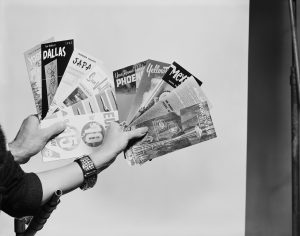 Hands holding various pamphlets